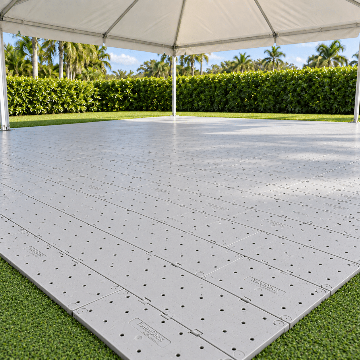 Light gray EventDeck modular flooring installed beneath a white frame tent