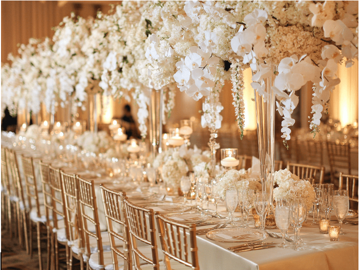 Outdoor reception with draped canopy and decorated tables